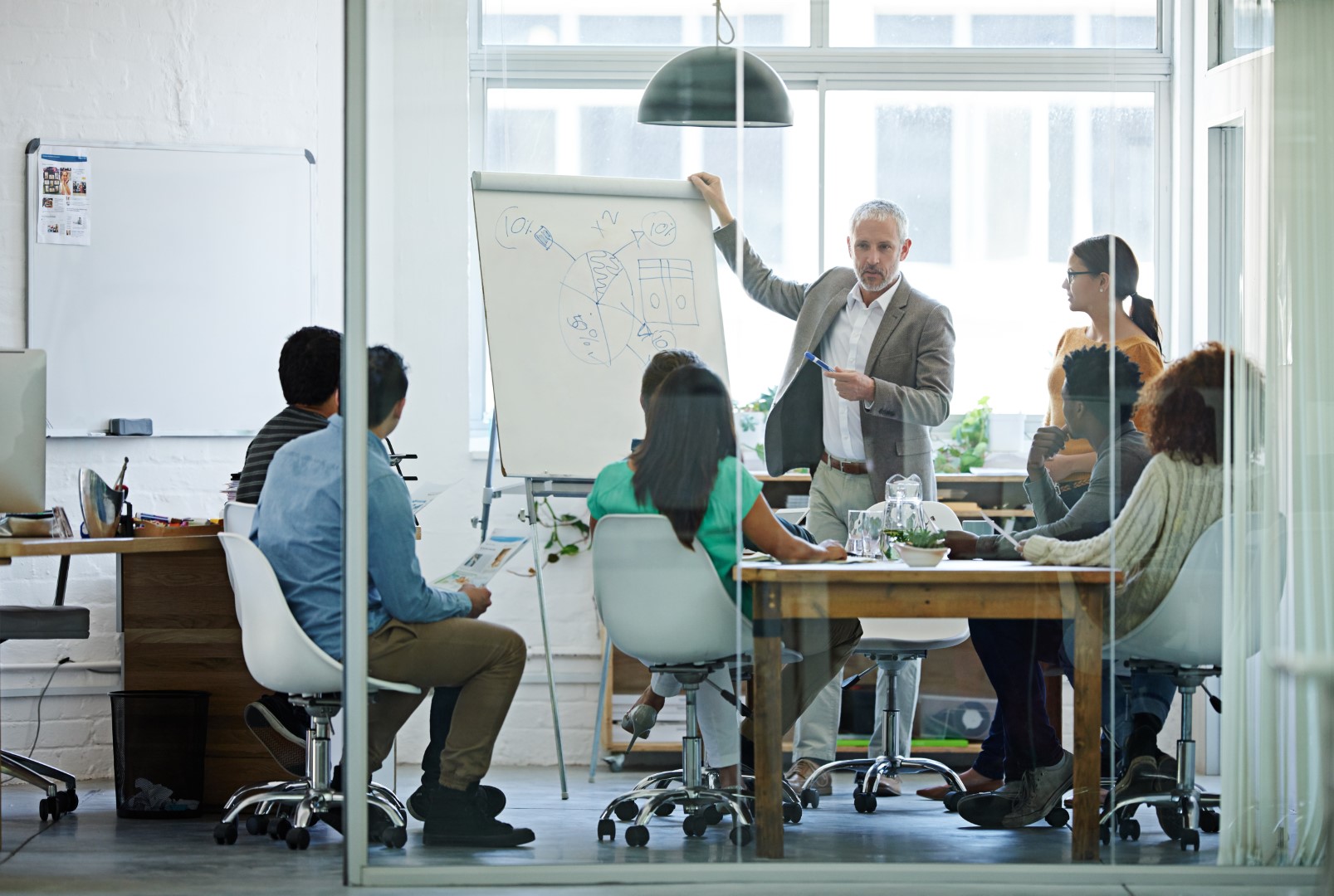 man presenting in a meeting room flip chart_mobile.jpeg