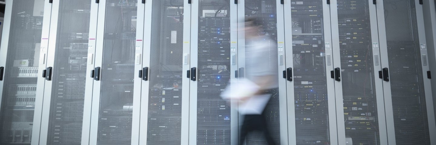 Man walking through server room Cropped.jpg