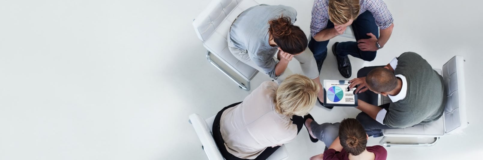five people talking over a tablet Cropped.jpg