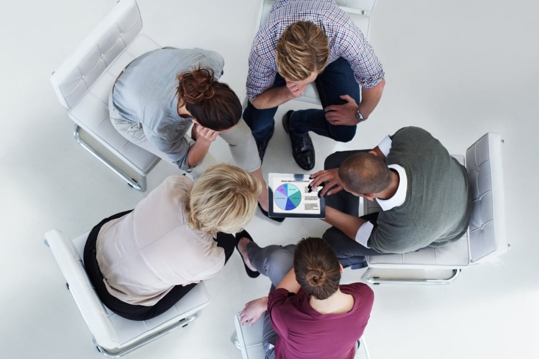 five people talking over a tablet_mobile.jpg