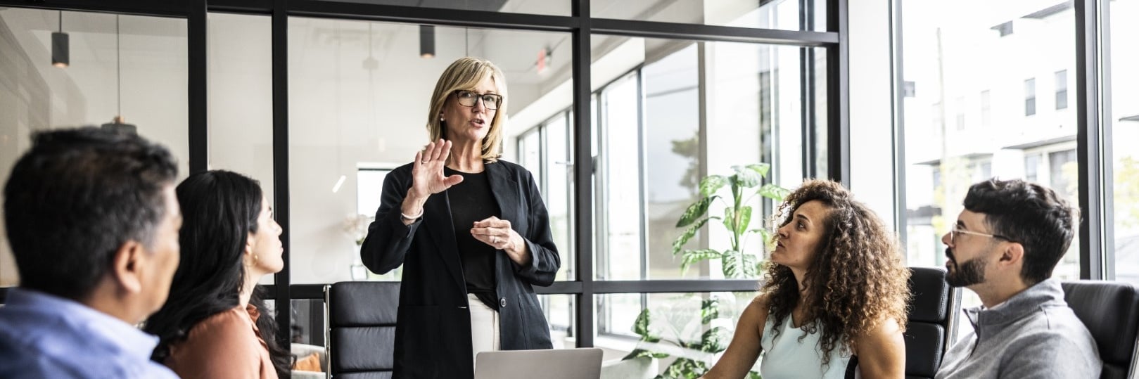 woman talking at a meeting in the office Cropped.jpg