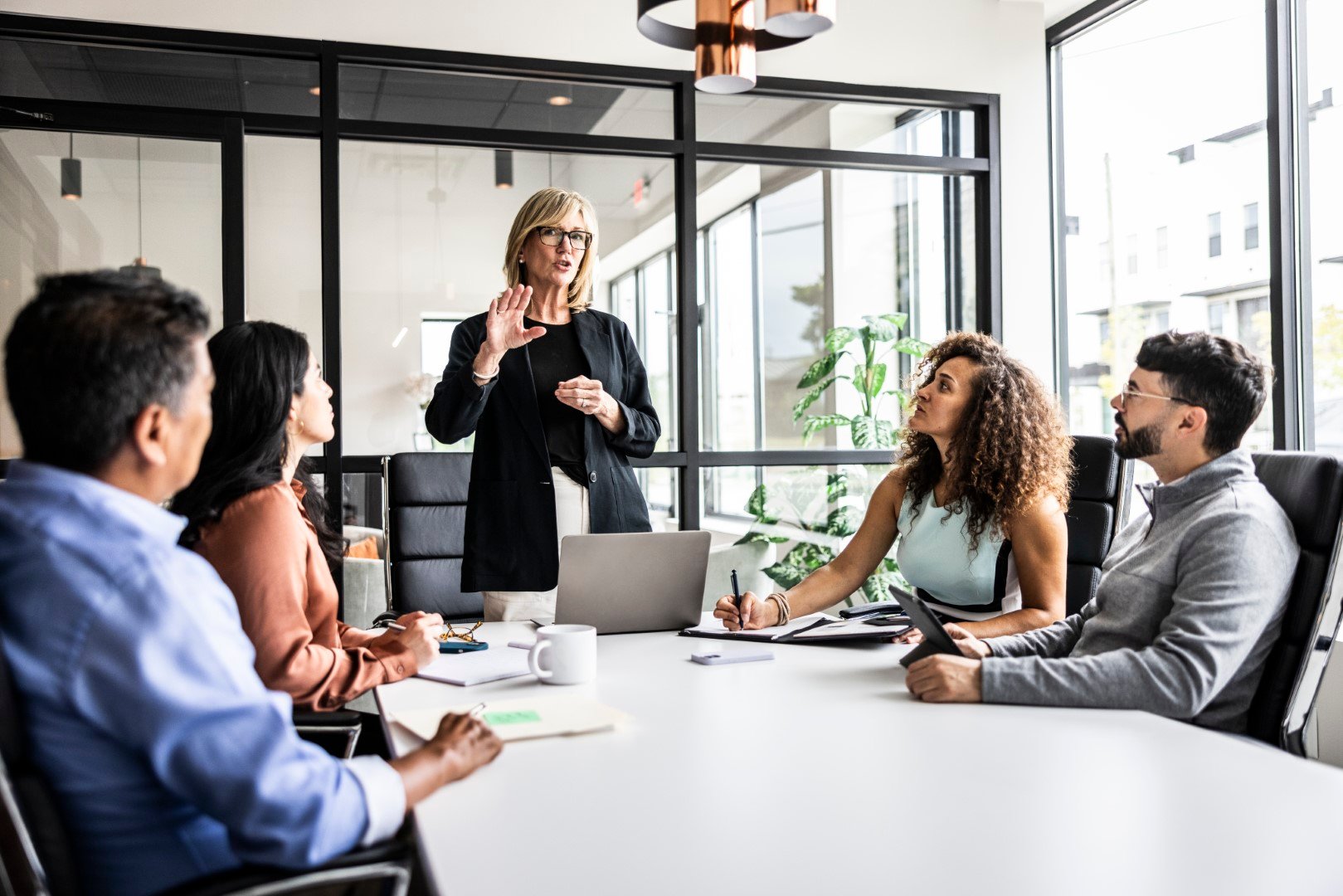woman talking at a meeting in the office.jpg