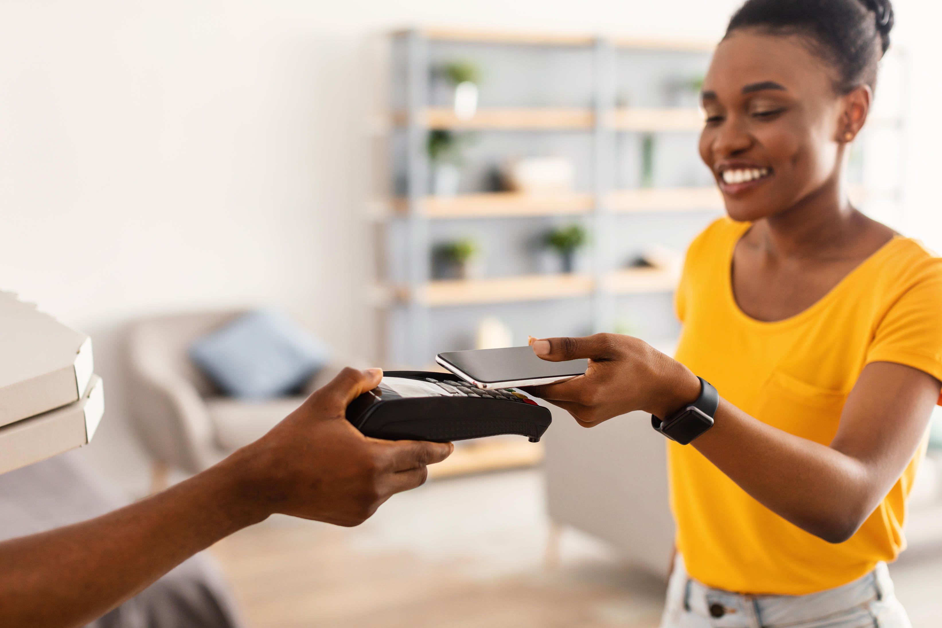 woman paying with phone.jpg