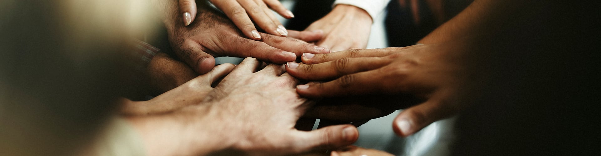 closeup-of-diverse-people-joining-their-hands.jpg