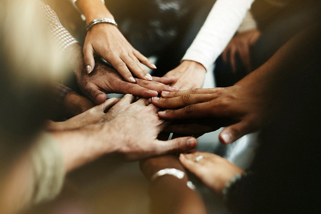 closeup-of-diverse-people-joining-their-hands.jpg